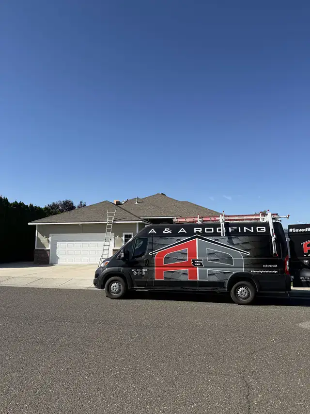 The A&A van in full wrap at a finished house, ladder still up