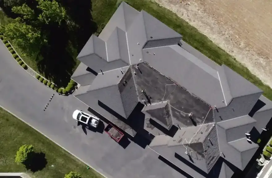 Aerial view of a large, complex roof with the A&A pickup in the drive