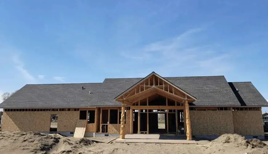 New-construction home with the roof on and a timber-framed entry