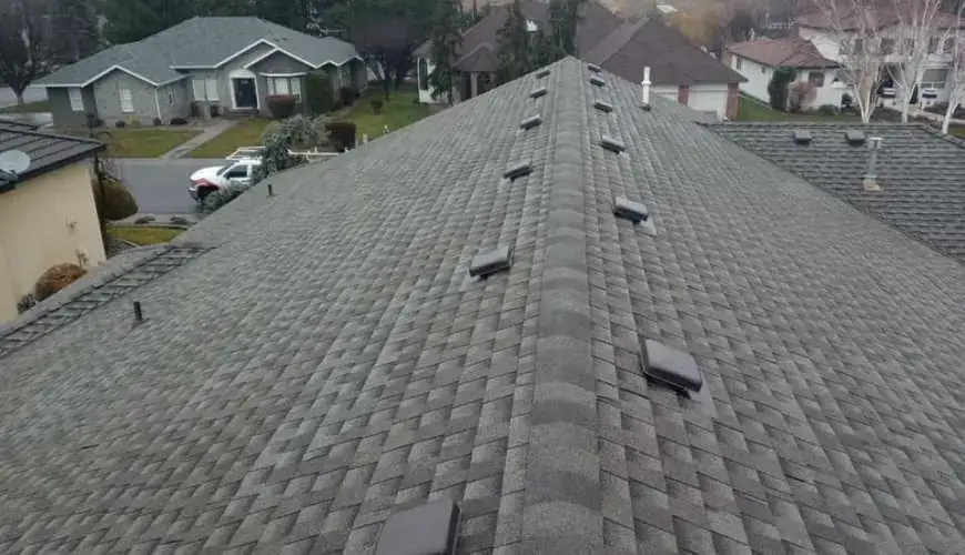 Drone view along a new shingle ridge with vents